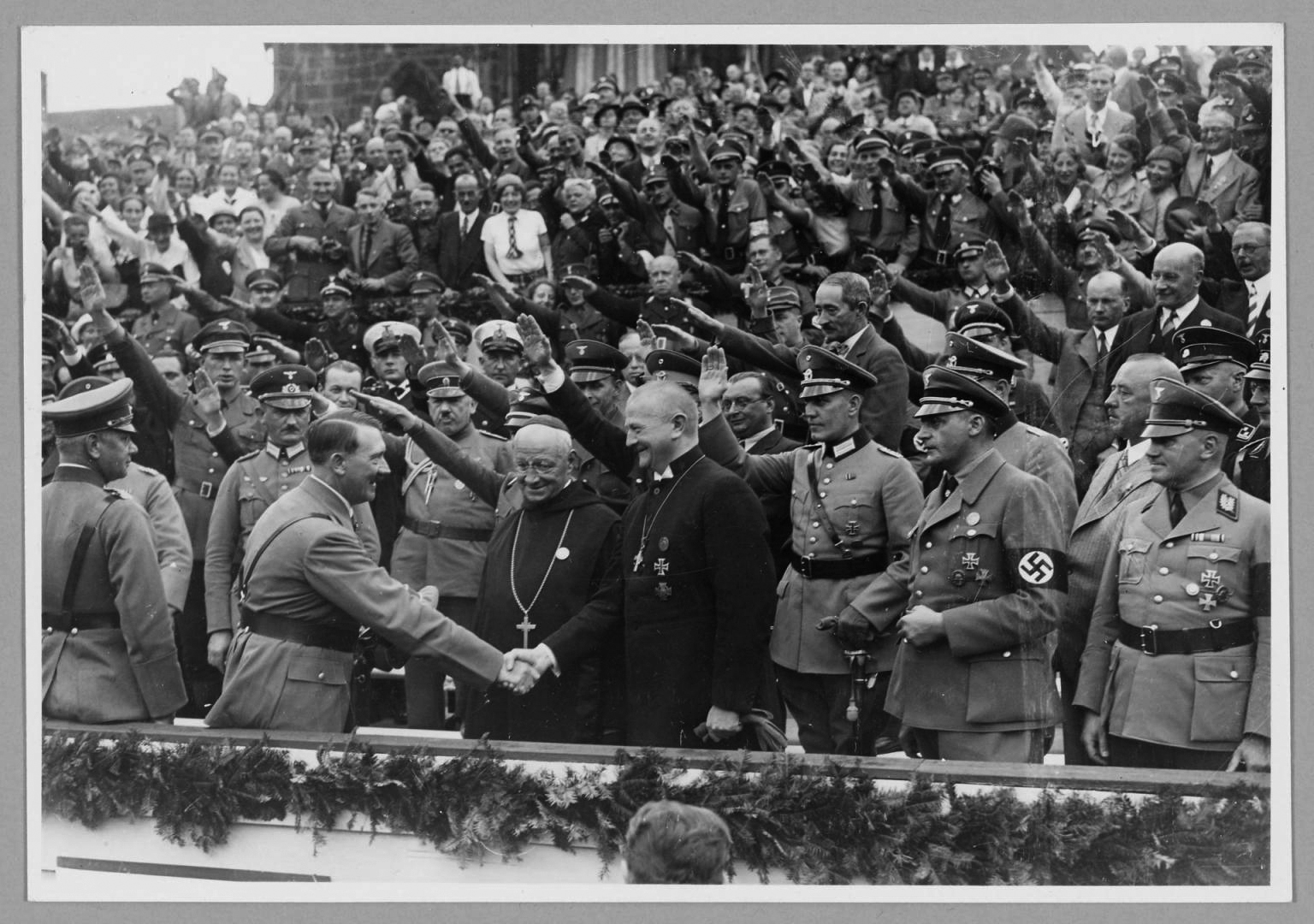 Hitler greets Reich Bishop Ludwig Muller and Abbott Albanus Schachleitner as Honorary guests at the Reich party rally for Unity and Strength